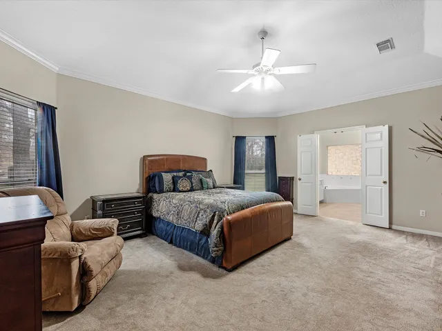 a spacious bedroom with a bed and window