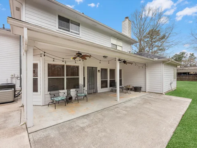 a view of a house with backyard porch and furniture