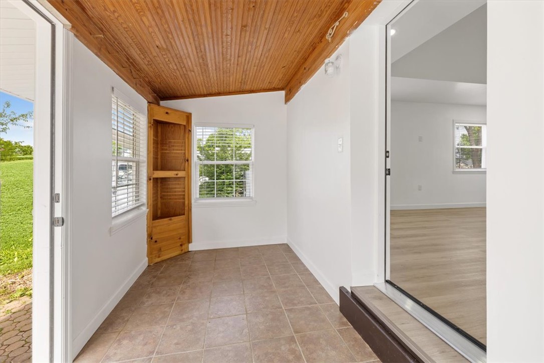 629 Little Meadow Drive Riverside, OH 45404 - Photo 9 of 48 This bright space features a unique wooden ceiling and durable tile flooring, connecting seamlessly to additional rooms.
