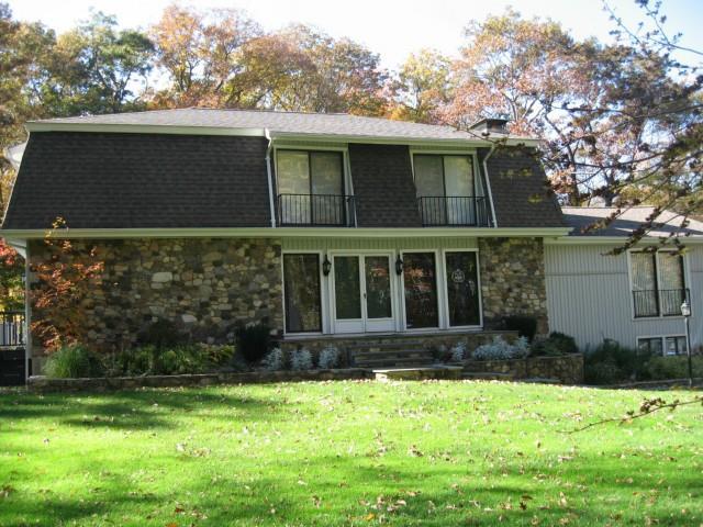 54 Bruschi Lane Ridgefield, CT 06877 - Photo 1 of 1 a front view of a house with a yard