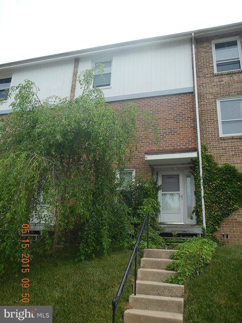 9132 Canterbury Riding, Unit 112 Laurel, MD 20723 - Photo 2 of 2 a front view of a house with garden