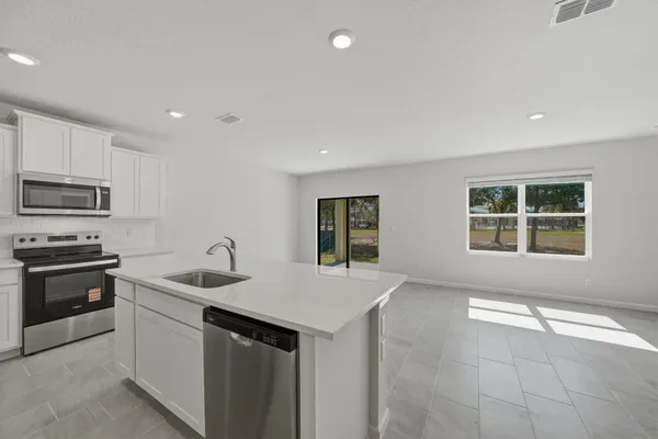 a kitchen with a sink stove and microwave