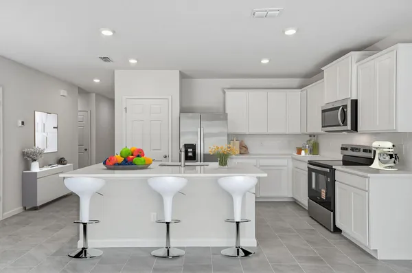 a kitchen that has a table and chairs in it