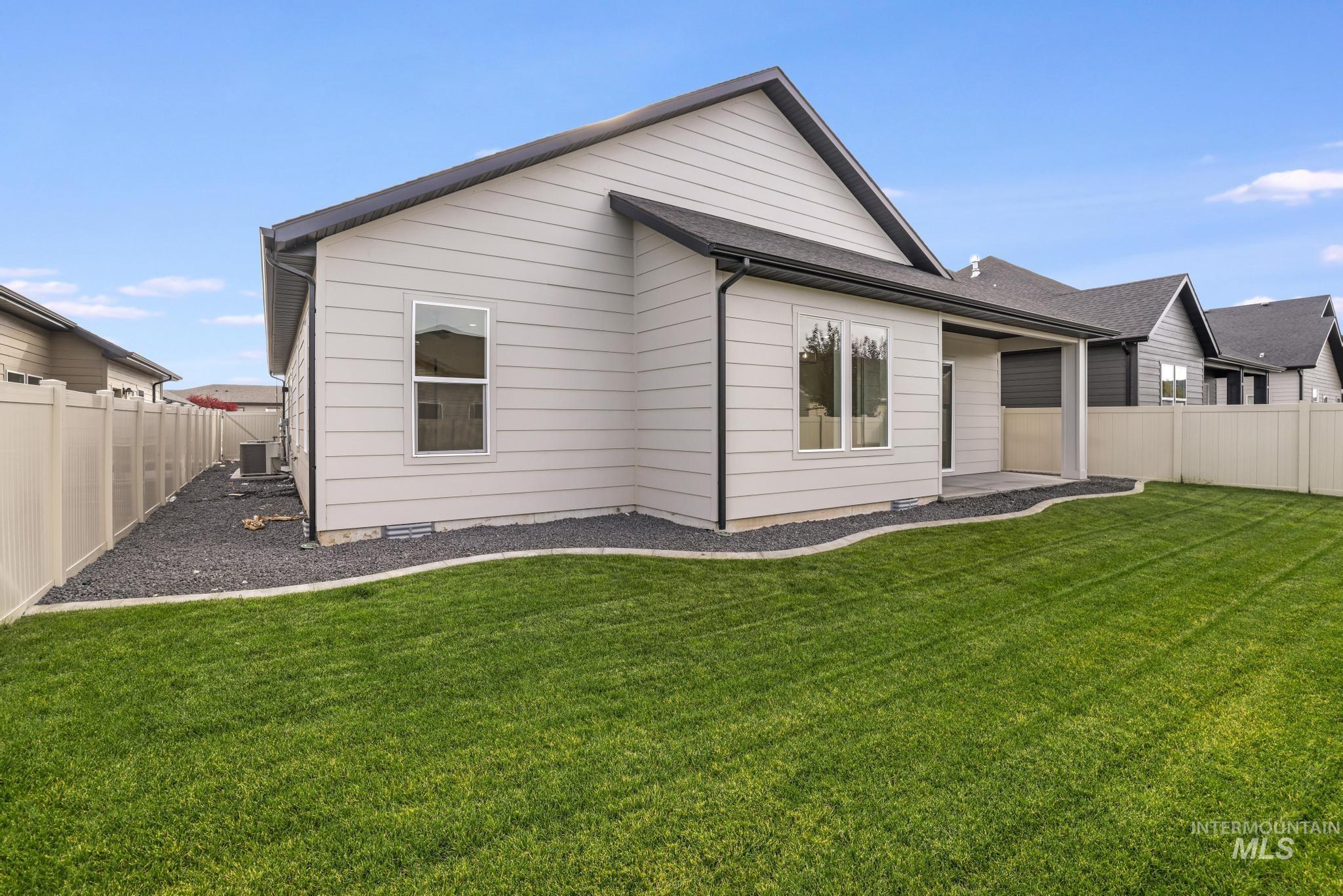 542 Falling Leaf Lane Twin Falls, ID 83301 - Photo 33 of 38 Rear view of house with a fenced backyard and a patio