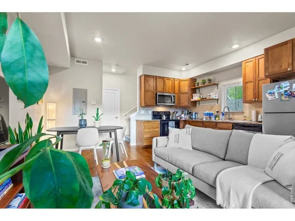 a living room with furniture and a kitchen