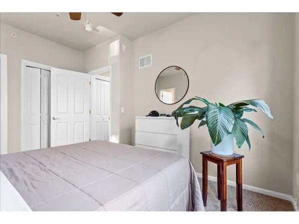 a bedroom with a bed and a potted plant