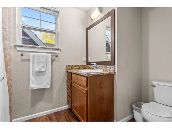 a bathroom with a sink a toilet and mirror