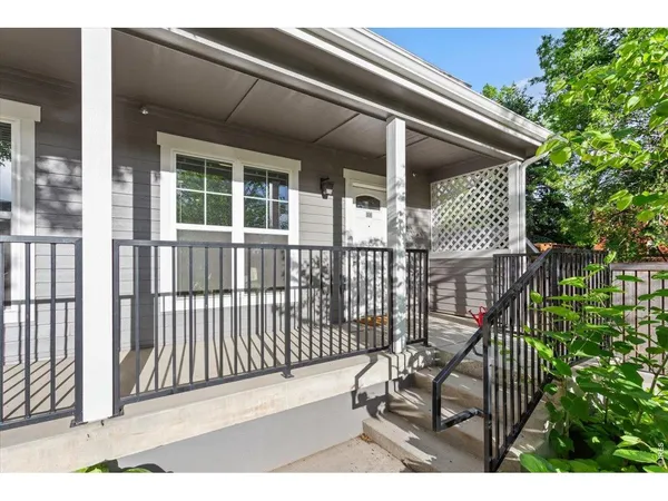 a view of a house with wooden deck