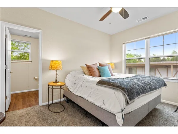 a spacious bedroom with a bed and window