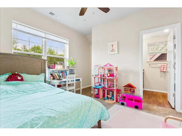 a bedroom with a bed and a large window