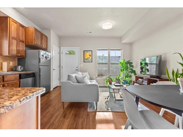 a living room with furniture and a dining table