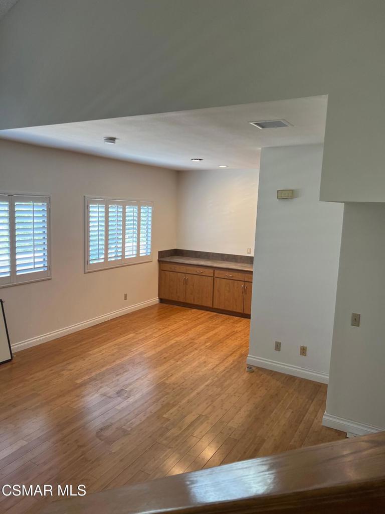 86 Maegan Place, Unit 10 Thousand Oaks, CA 91362 - Photo 5 of 15 a view of an empty room with wooden floor and a window