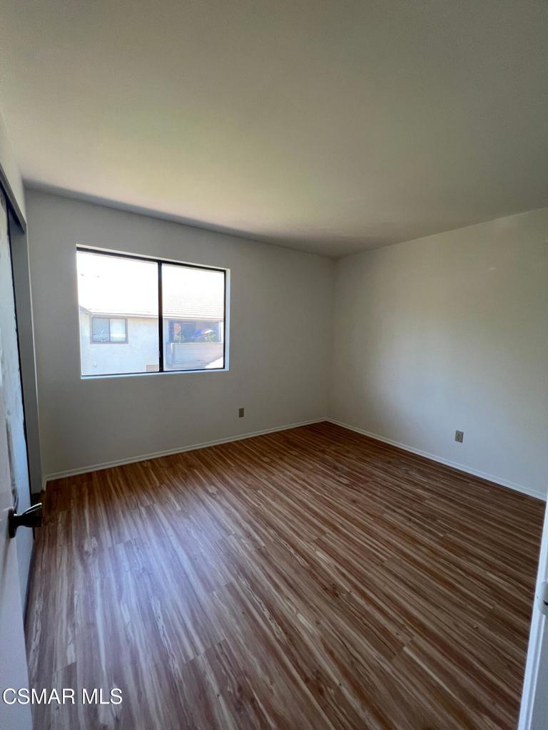 86 Maegan Place, Unit 10 Thousand Oaks, CA 91362 - Photo 9 of 15 an empty room with wooden floor and windows