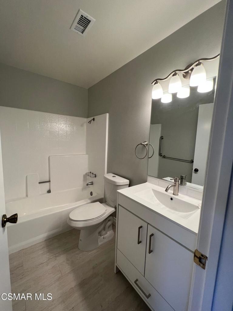 86 Maegan Place, Unit 10 Thousand Oaks, CA 91362 - Photo 10 of 15 a bathroom with a double vanity sink mirror and toilet