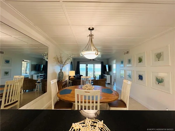 a view of a dining room and hall with furniture