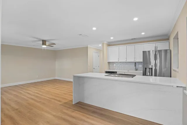 a kitchen with stainless steel appliances a refrigerator sink and stove