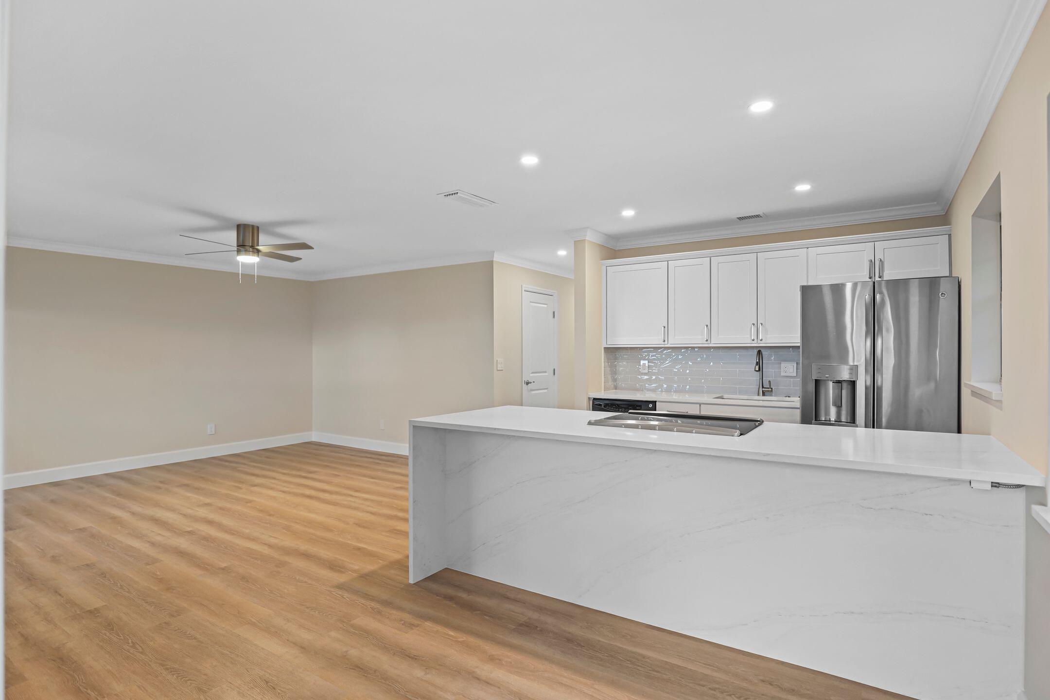 2929 Southeast Ocean Boulevard, Unit 1406 Stuart, FL 34996 - Photo 11 of 27 a kitchen with stainless steel appliances a refrigerator sink and stove