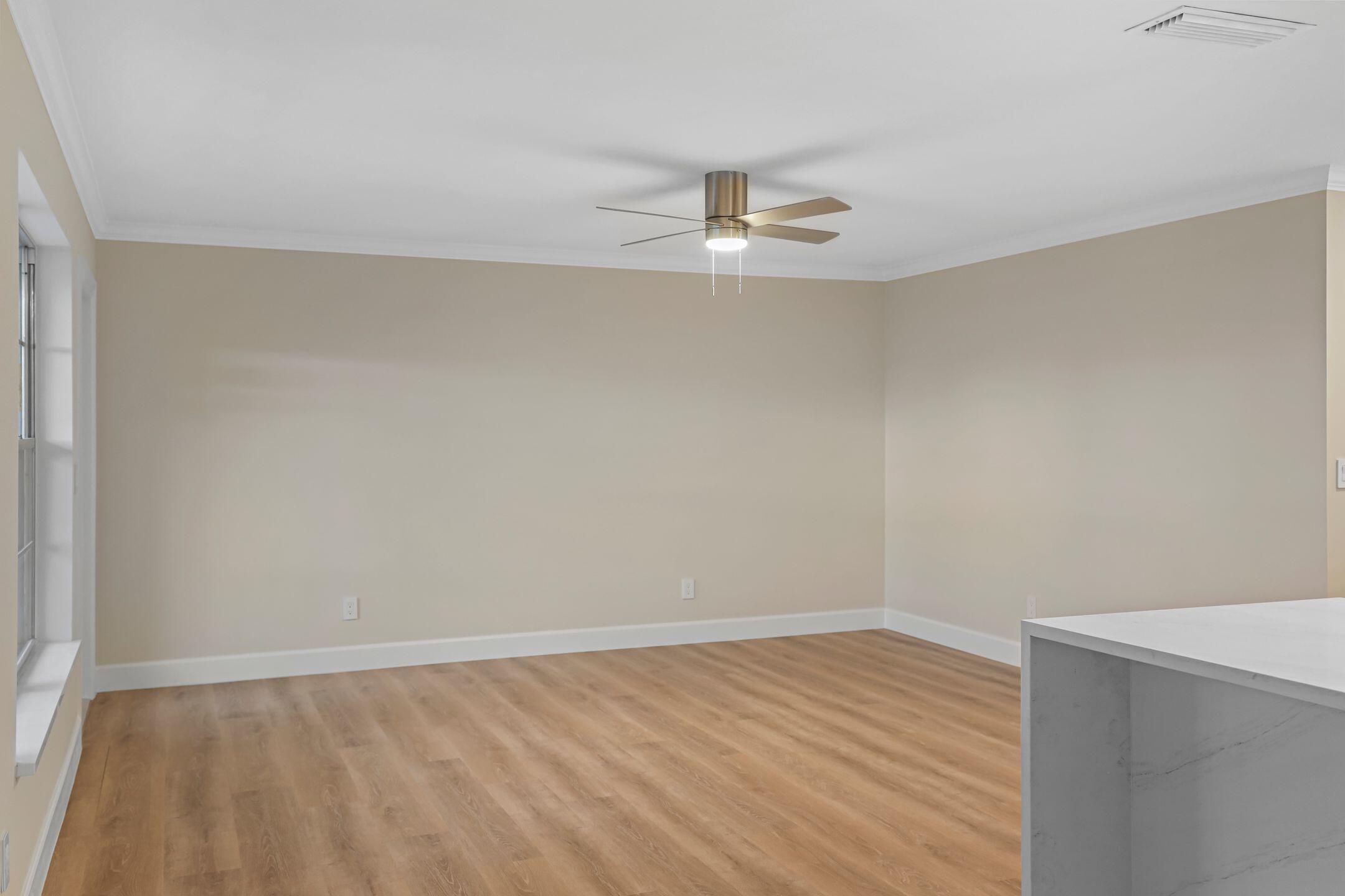 2929 Southeast Ocean Boulevard, Unit 1406 Stuart, FL 34996 - Photo 12 of 27 wooden floor in an empty room with a window