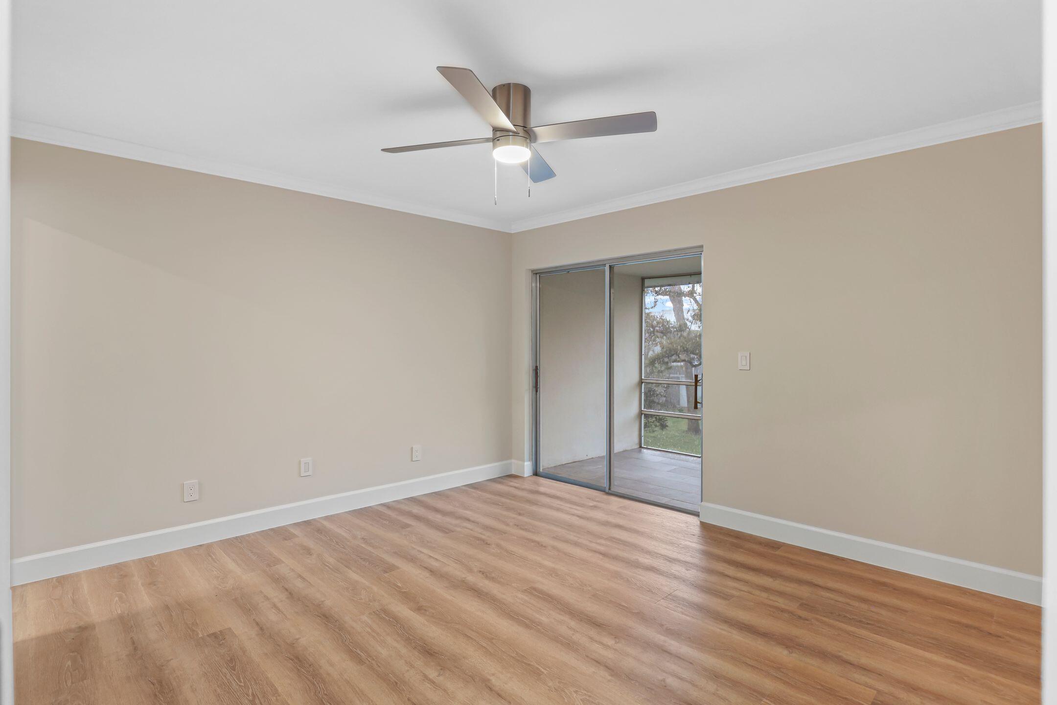 2929 Southeast Ocean Boulevard, Unit 1406 Stuart, FL 34996 - Photo 14 of 27 a view of an empty room with wooden floor