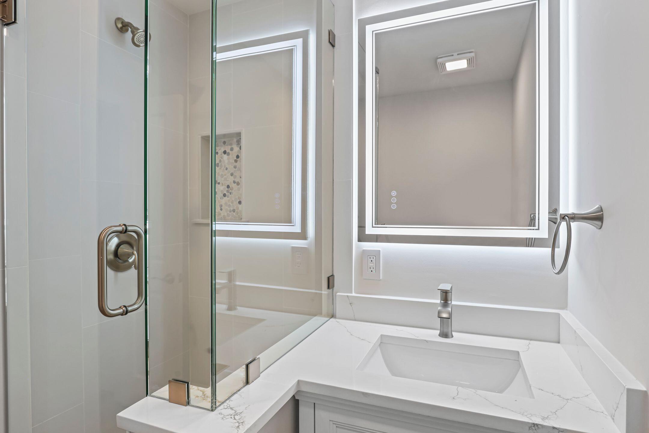 2929 Southeast Ocean Boulevard, Unit 1406 Stuart, FL 34996 - Photo 18 of 27 a bathroom with a sink and a mirror