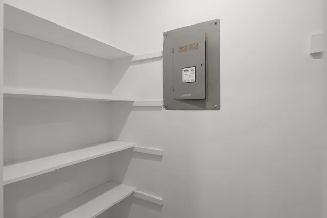 a view of staircase with white walls and white door