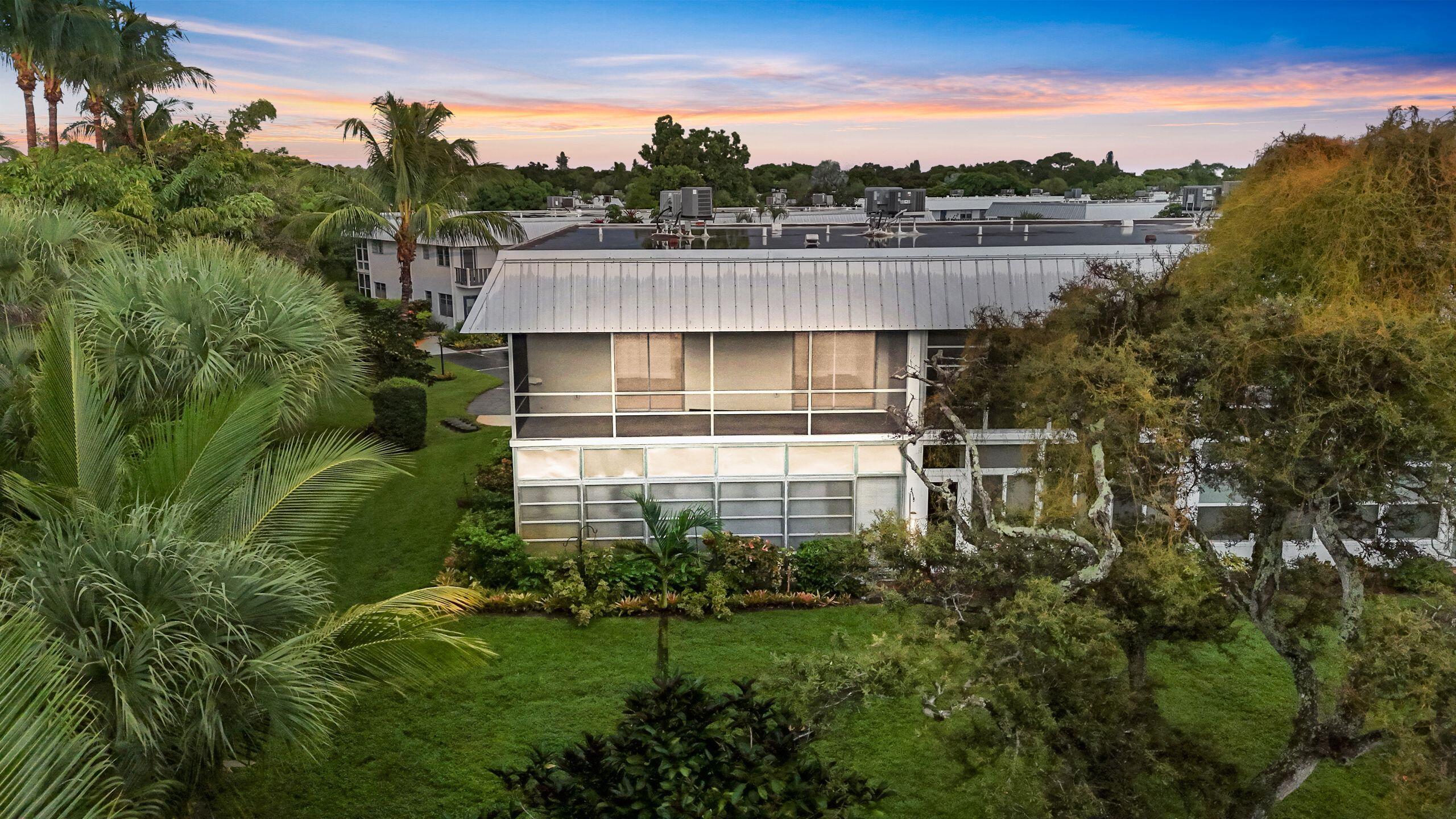 2929 Southeast Ocean Boulevard, Unit 1406 Stuart, FL 34996 - Photo 2 of 27 a backyard of a house with a garden and outdoor seating