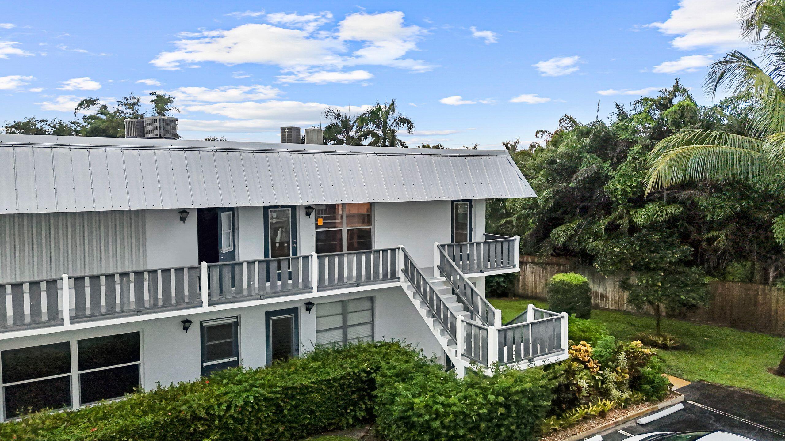 2929 Southeast Ocean Boulevard, Unit 1406 Stuart, FL 34996 - Photo 24 of 27 a aerial view of a house with a yard and potted plants