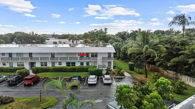 a view of a cars park in front of a house