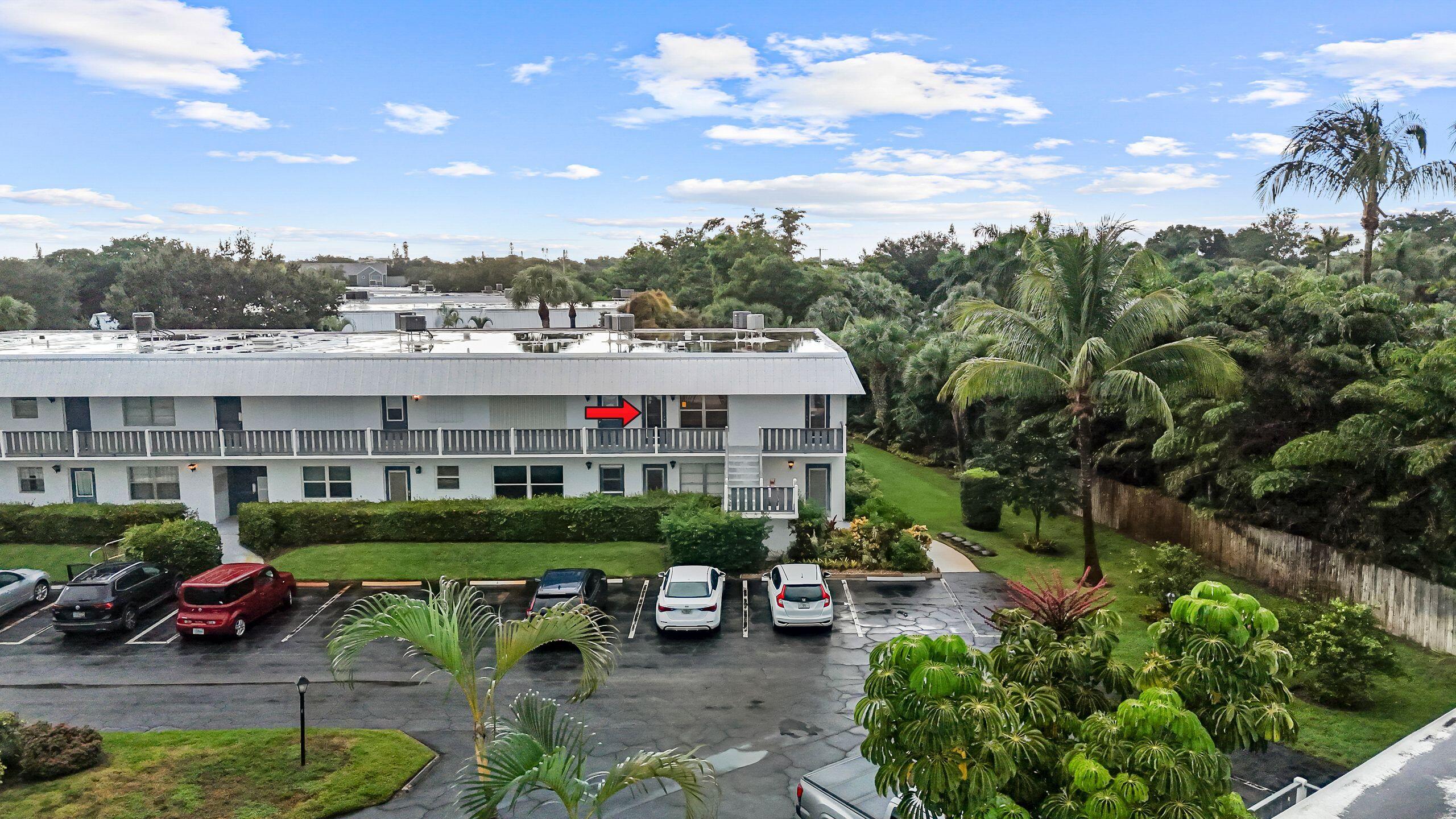 2929 Southeast Ocean Boulevard, Unit 1406 Stuart, FL 34996 - Photo 3 of 27 a view of a cars park in front of a house