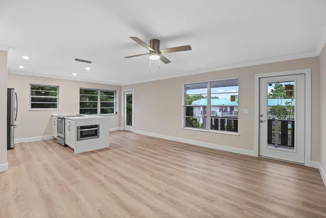 a view of a livingroom with wooden floor and windows