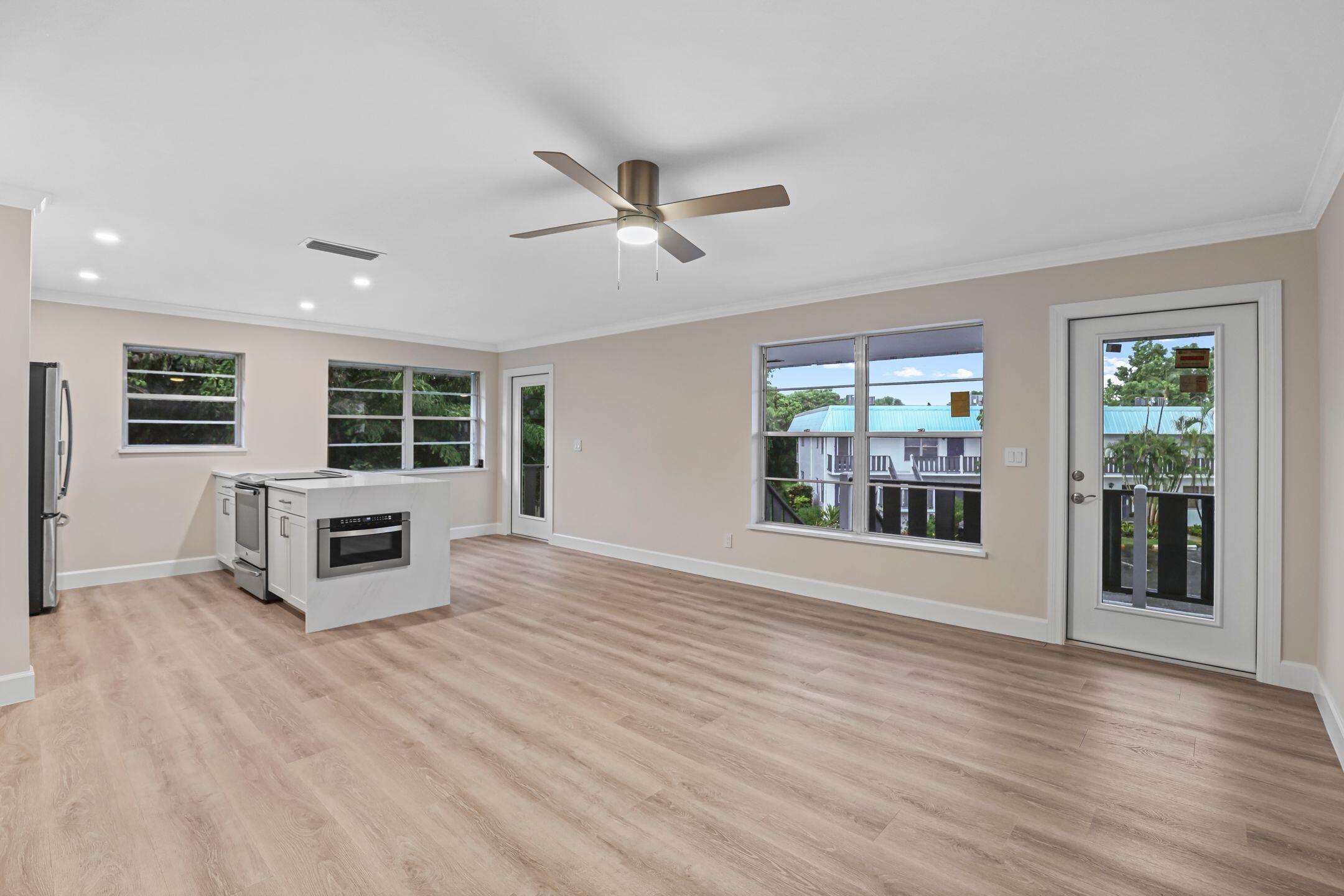 2929 Southeast Ocean Boulevard, Unit 1406 Stuart, FL 34996 - Photo 6 of 27 a view of a livingroom with wooden floor and windows