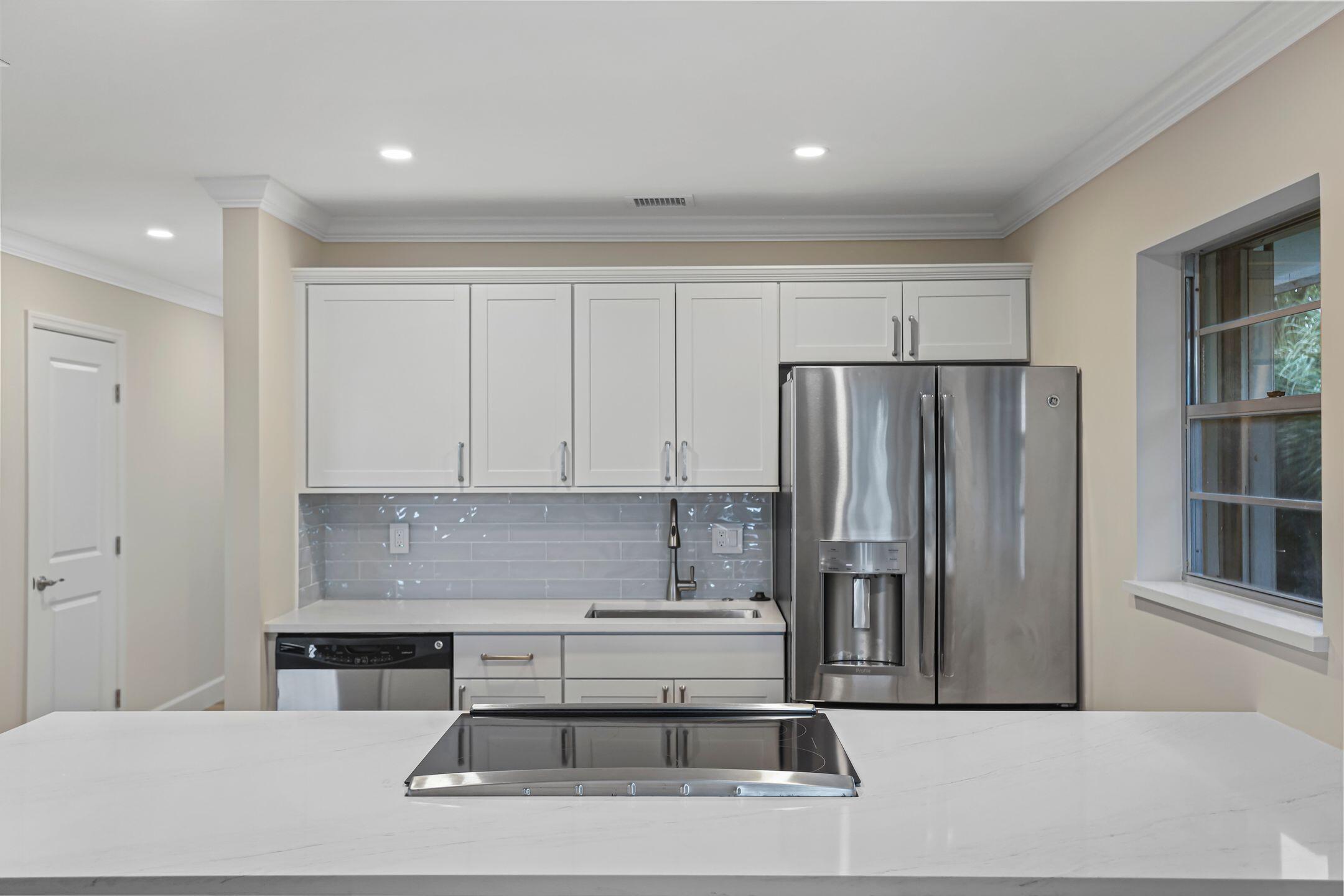 2929 Southeast Ocean Boulevard, Unit 1406 Stuart, FL 34996 - Photo 8 of 27 a kitchen with stainless steel appliances granite countertop a refrigerator and a stove