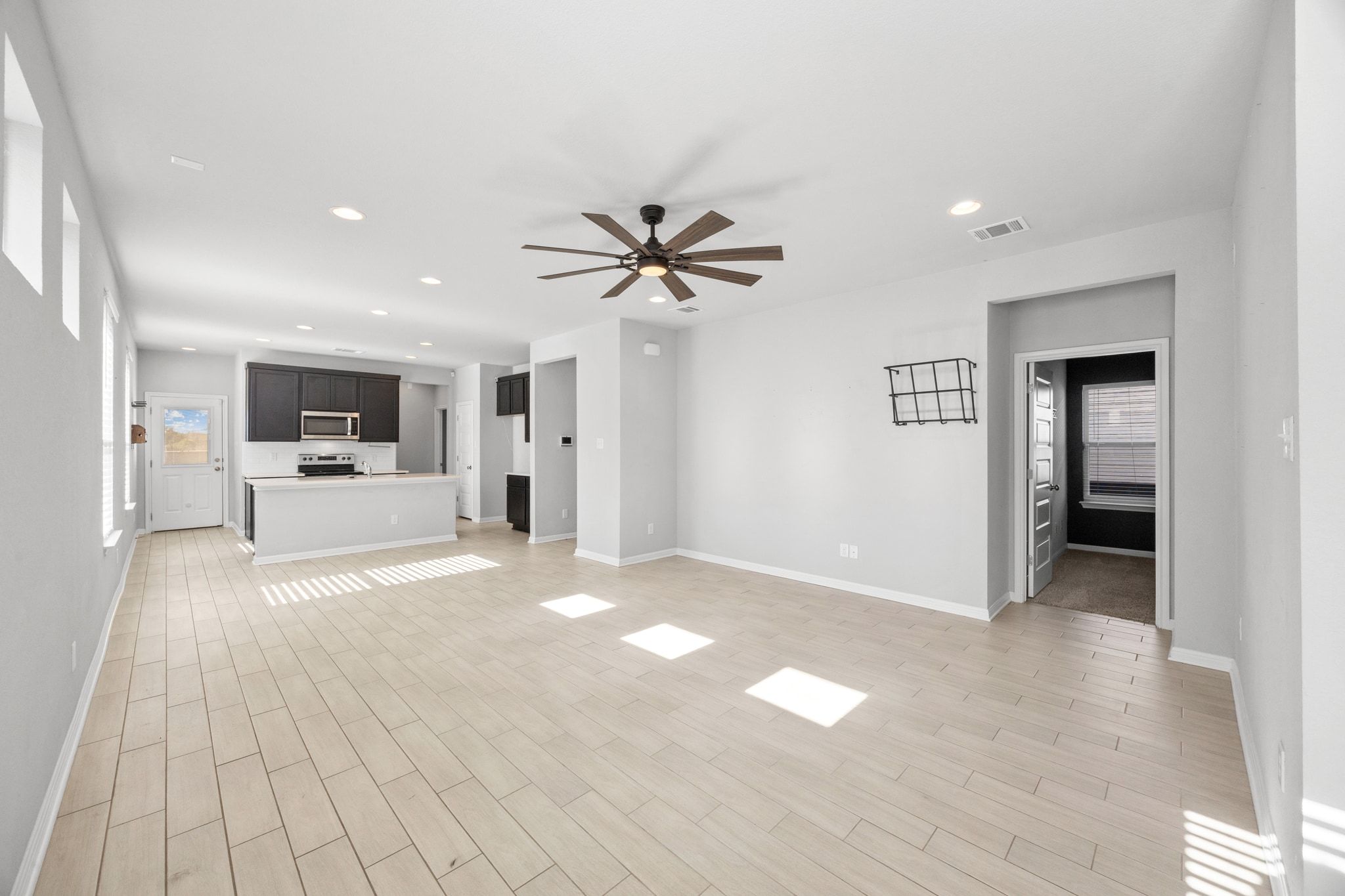 225 Unforgiven Lane Jarrell, TX 76537 - Photo 5 of 30 Unfurnished living room with recessed lighting, ceiling fan, and light wood-style floors