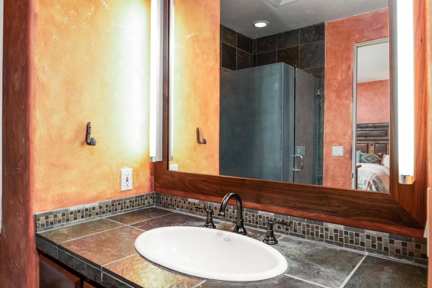 27835 Mesa Del Toro Road Salinas, CA 93908 - Photo 23 of 44 a bathroom with a granite countertop sink and a mirror