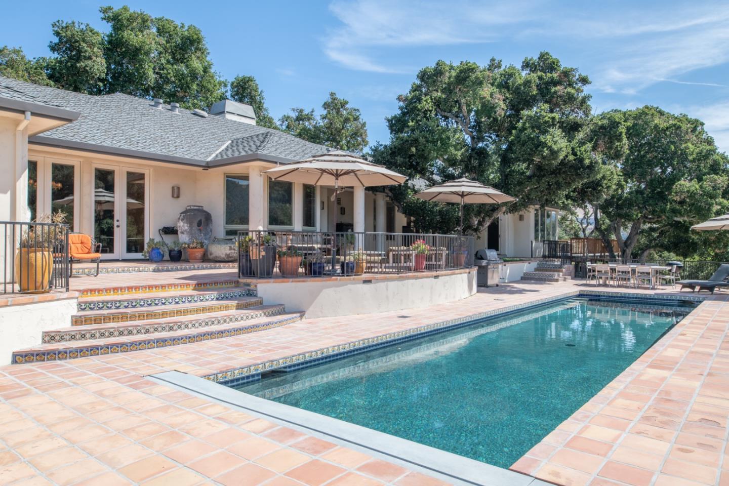 27835 Mesa Del Toro Road Salinas, CA 93908 - Photo 29 of 44 a view of a patio with couches and table and chairs with umbrella