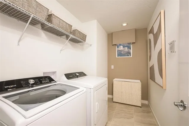 a view of storage and utility room with washer and dryer