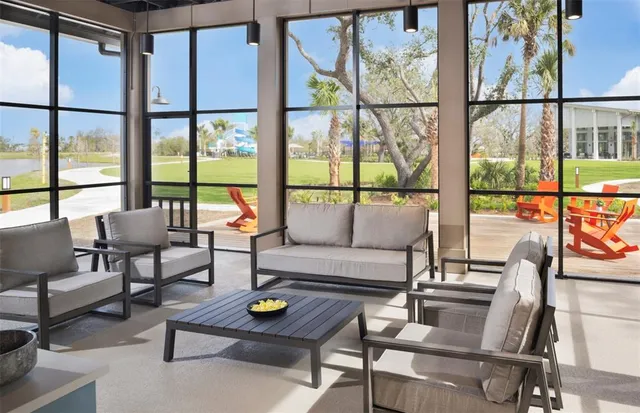 a living room with furniture and a floor to ceiling window