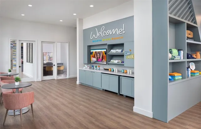 a kitchen with stainless steel appliances kitchen island wooden floors and wooden cabinets