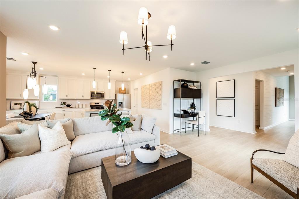 11346 Meadow River Way Parrish, FL 34219 - Photo 6 of 25 a living room with furniture potted plant and kitchen view