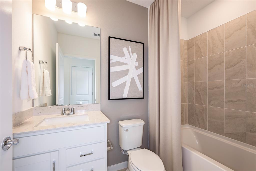 11346 Meadow River Way Parrish, FL 34219 - Photo 10 of 25 a bathroom with a toilet sink and mirror