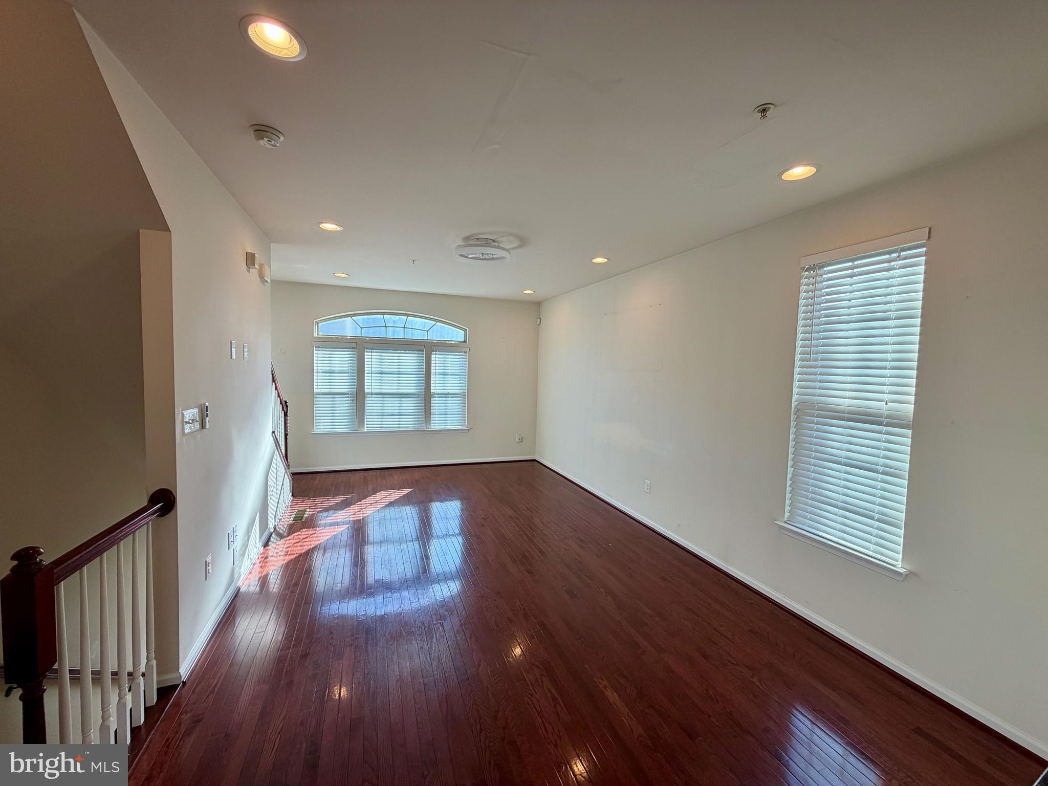 7729 Duncannon Lane Hanover, MD 21076 - Photo 13 of 26 a view of an empty room with wooden floor and a window