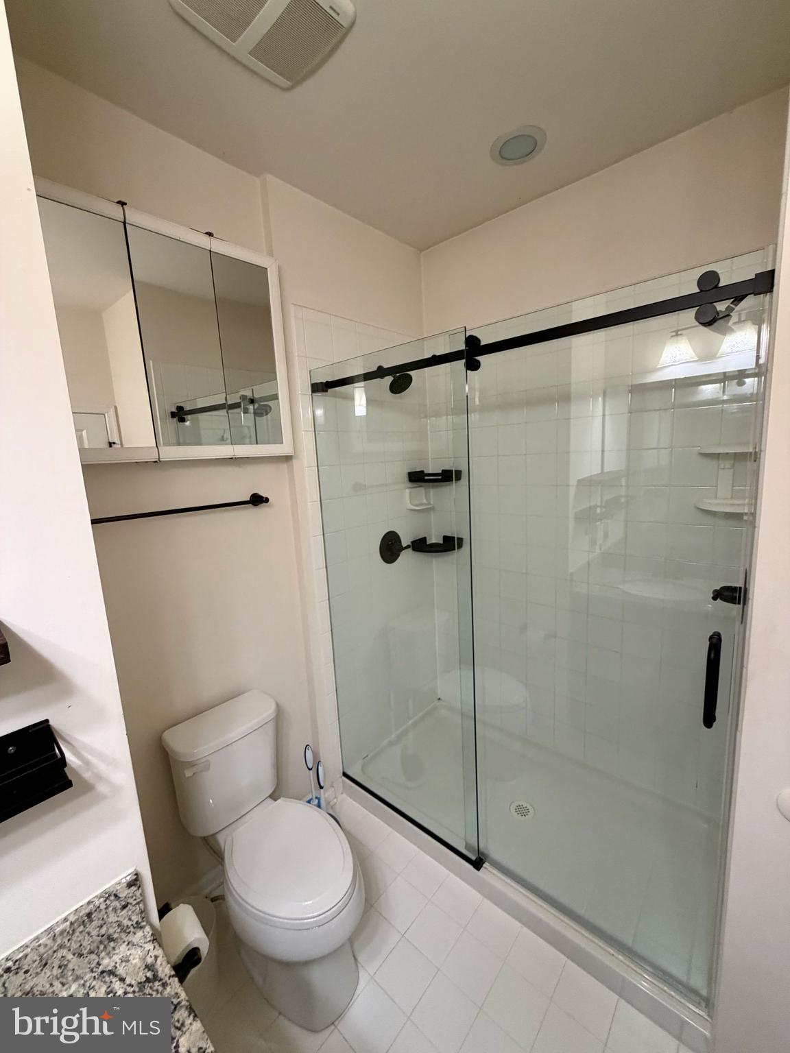 7729 Duncannon Lane Hanover, MD 21076 - Photo 18 of 26 a bathroom with a toilet and a shower