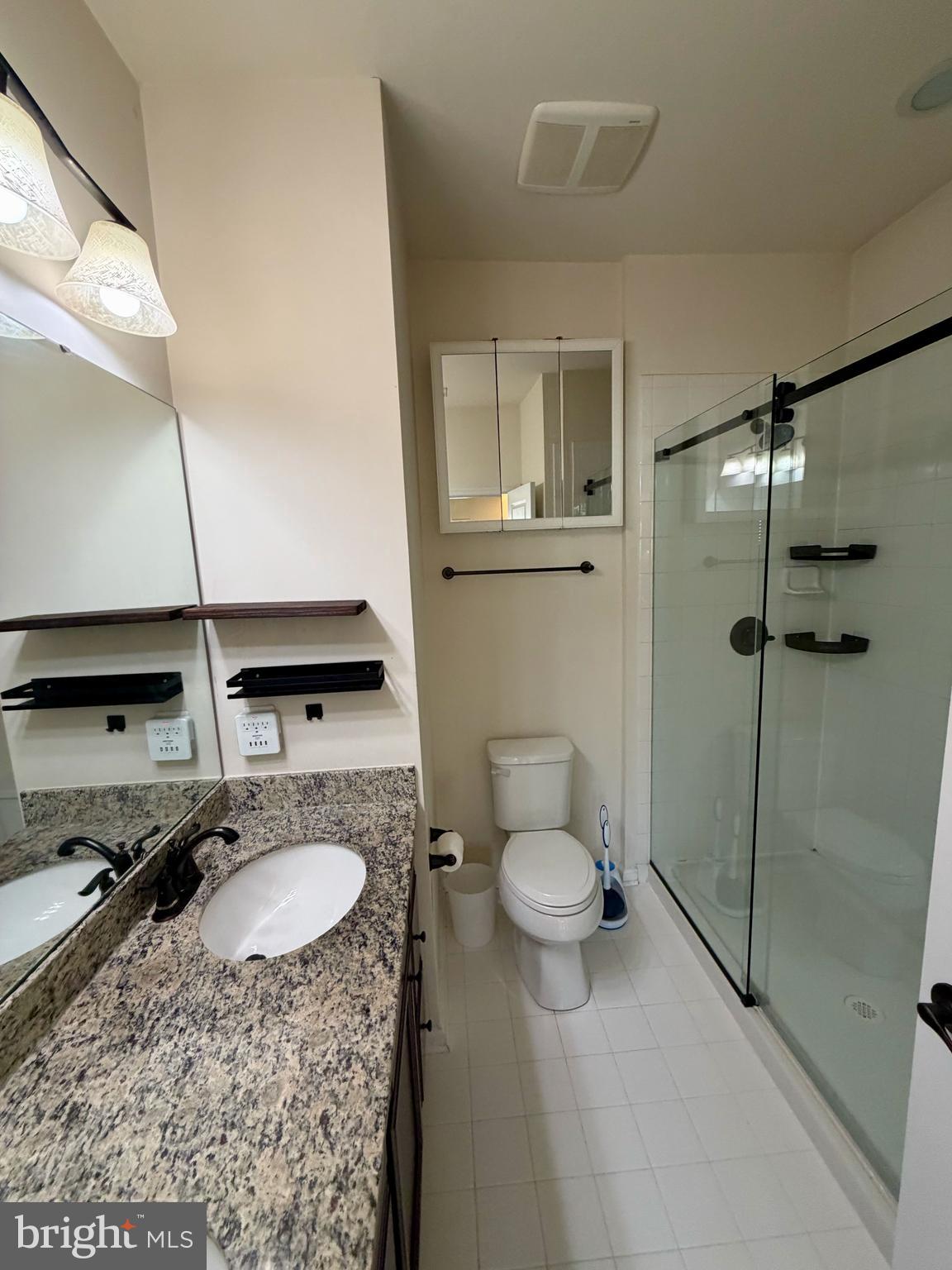 7729 Duncannon Lane Hanover, MD 21076 - Photo 20 of 26 a bathroom with a sink toilet and shower