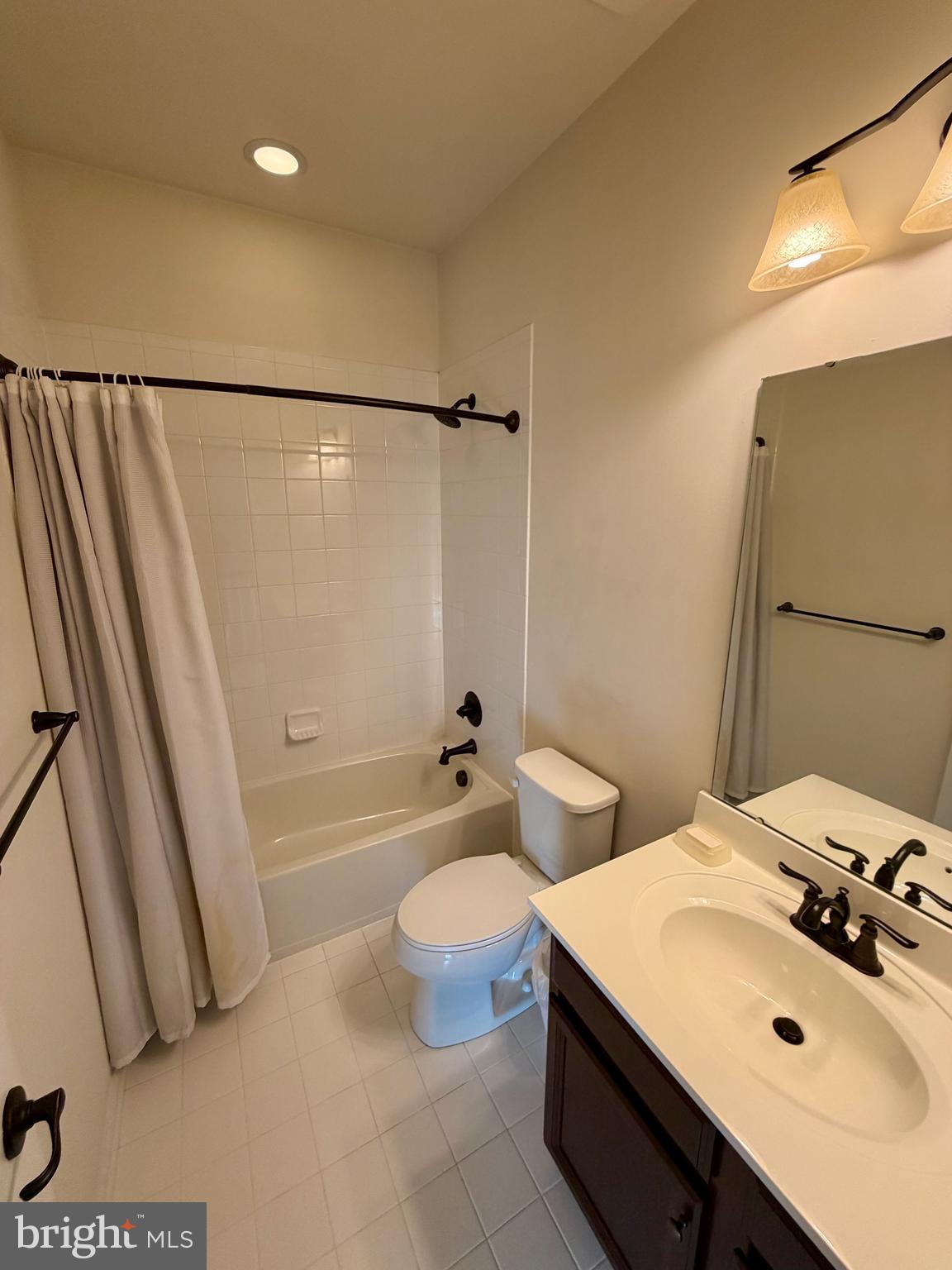 7729 Duncannon Lane Hanover, MD 21076 - Photo 23 of 26 a bathroom with a sink a toilet and shower