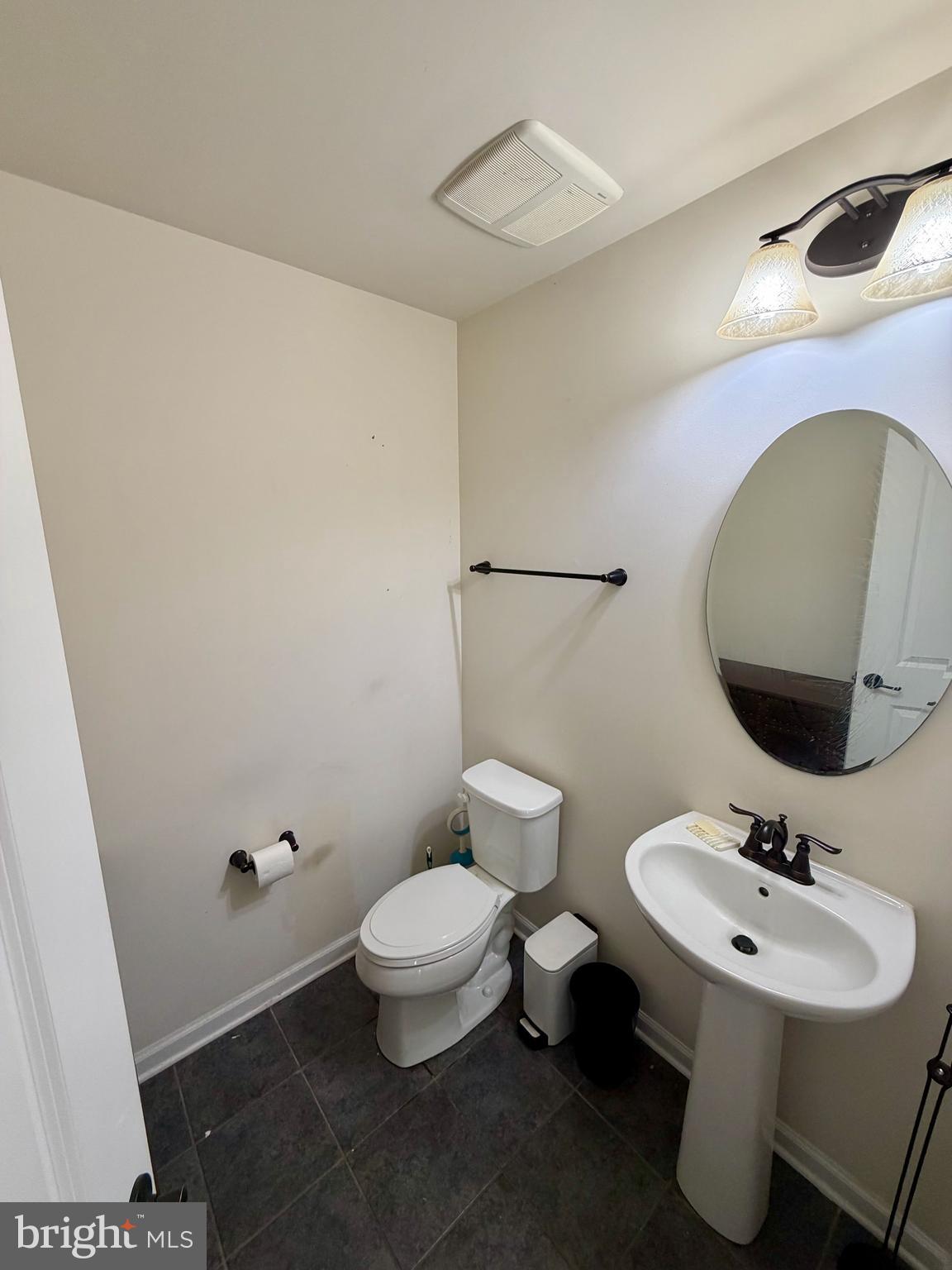 7729 Duncannon Lane Hanover, MD 21076 - Photo 6 of 26 a bathroom with a sink toilet and mirror