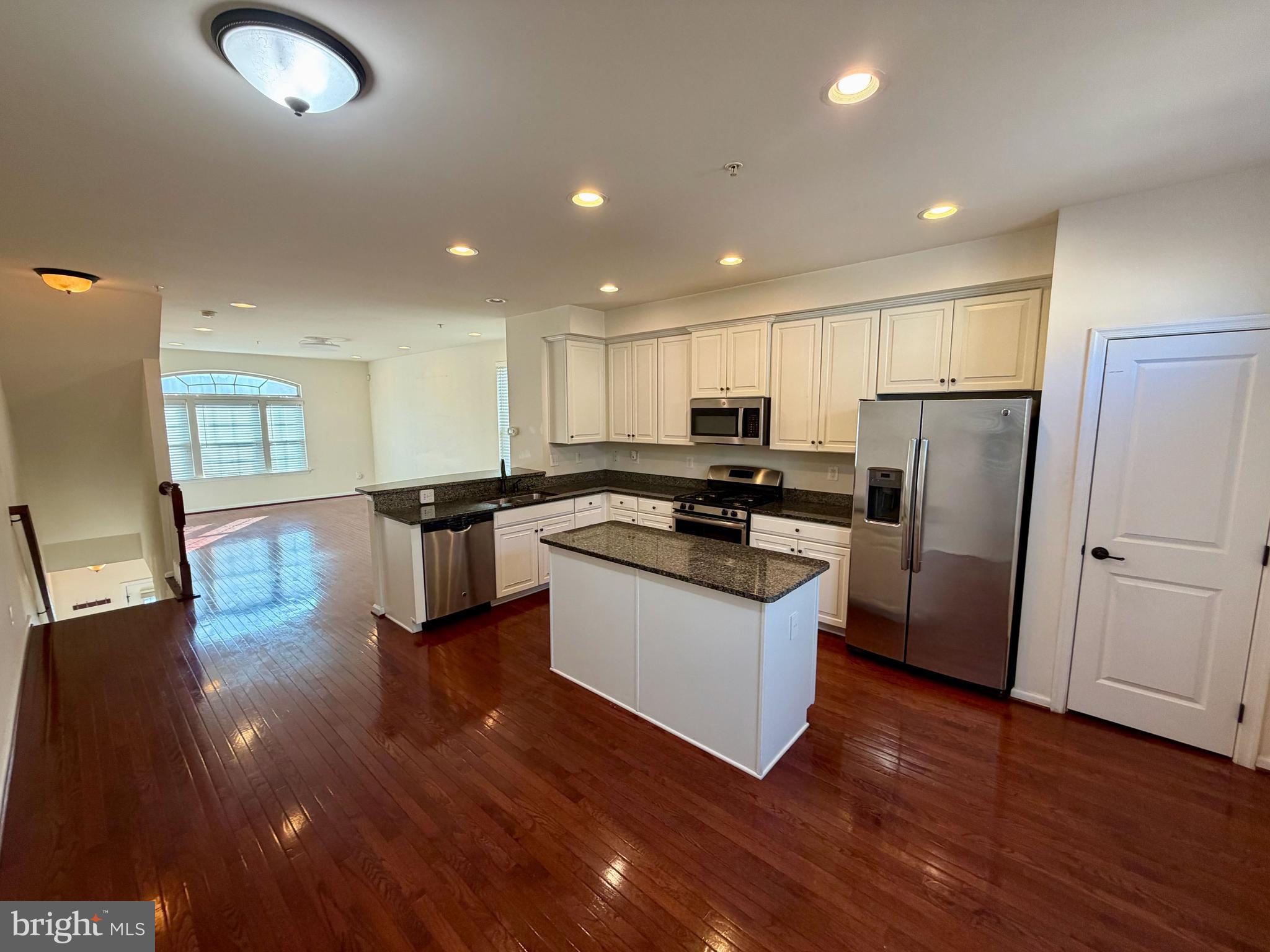 7729 Duncannon Lane Hanover, MD 21076 - Photo 7 of 26 a kitchen with a refrigerator sink and cabinets