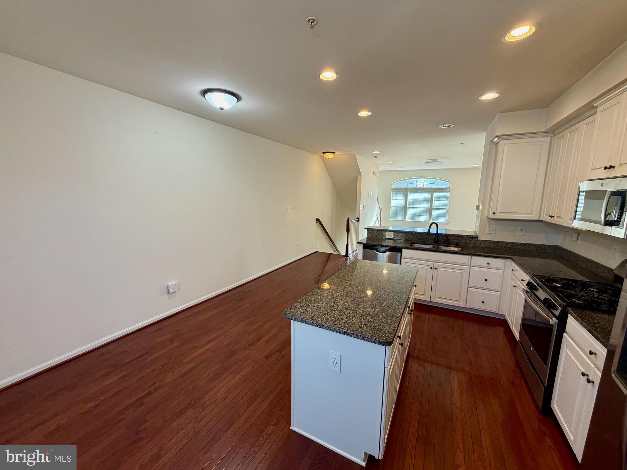 7729 Duncannon Lane Hanover, MD 21076 - Photo 9 of 26 a kitchen with granite countertop a sink stove and refrigerator