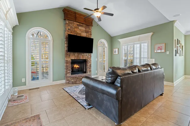 a large living room with furniture and a large window