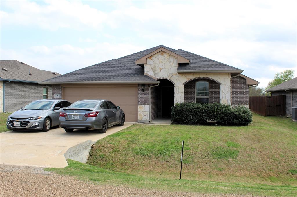 515 Cottage Row Mabank, TX 75147 - Photo 1 of 16 a front view of a house with cars parked