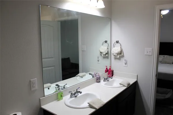 a bathroom with a sink vanity and a mirror
